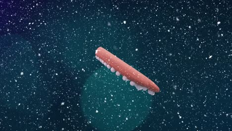 animation of christmas heart gingerbread cookie over snow falling