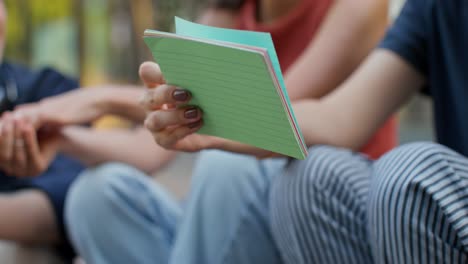 friends holding notepad outdoors