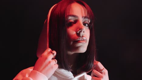 moody portrait of a mysterious women in hooded sweatshirt
