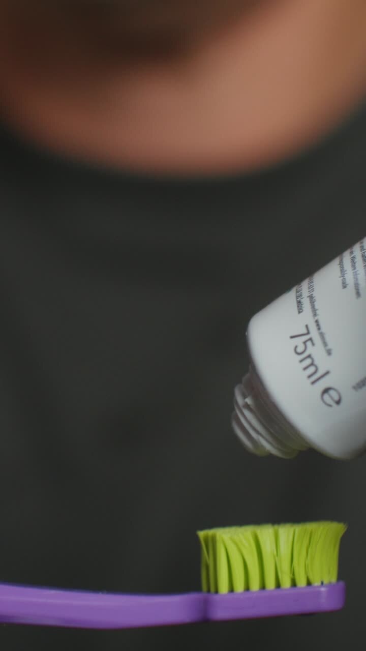 Applying toothpaste to a toothbrush