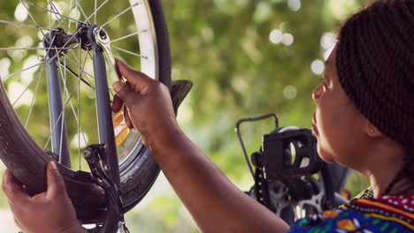 woman performing bike maintenance