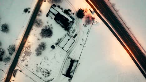 Aerial-over-a-road-junction-in-an-snowy-landscape-near-Voss,-Norway