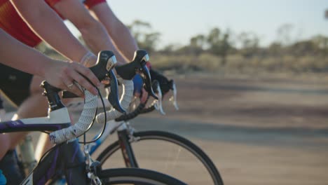 hands and handlebar close up tracking shot of cyclists