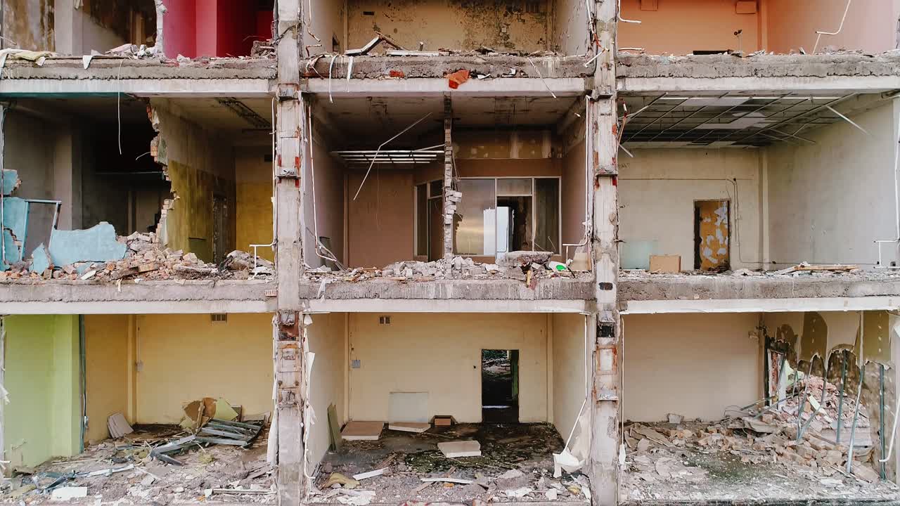 Demolished apartment block sliced open, revealing empty cubical room interiors