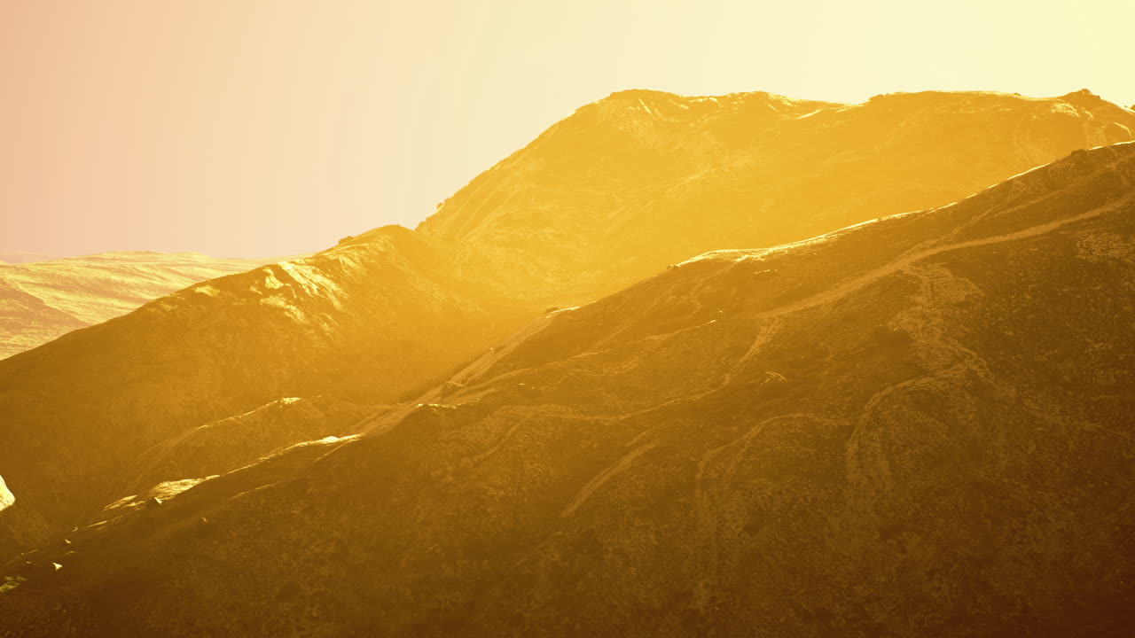 Stunning sunset over rugged mountains highlights natures beauty