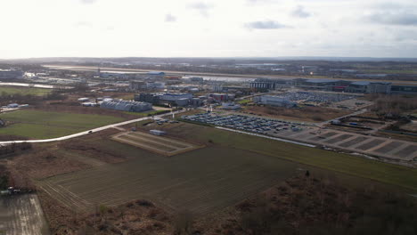 Drone-wide-shot-of-Airport-of-Gdansk-in-Poland-with-parking-cars-during-cloudy-day