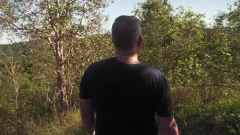 slow motion following man walking downhill.