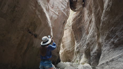 woman exploring a narrow canyon