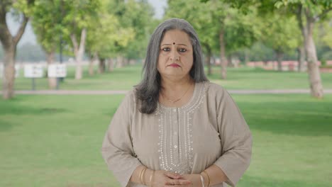 Indian-old-woman-staring-at-the-camera-in-park