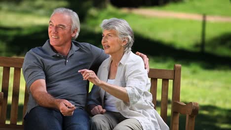 Senior-couple-talking-on-a-bench