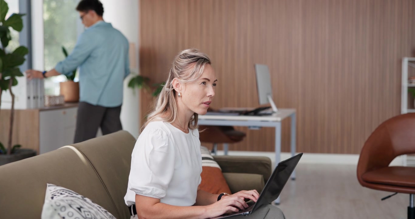 Professional Woman Working on Laptop in Modern Office