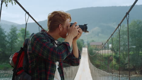 closeup hipster photographing mountains landscape. hiker take camera photo.