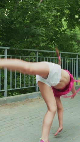 a young girl in pink attire expresses joy and movement in a lively outdoor setting, showcasing playful energy and confidence as she poses and moves