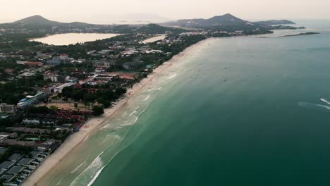 aerial top view of samui island thailand form drone sunset sky, white beach and green blue sea, copy space and slow motion