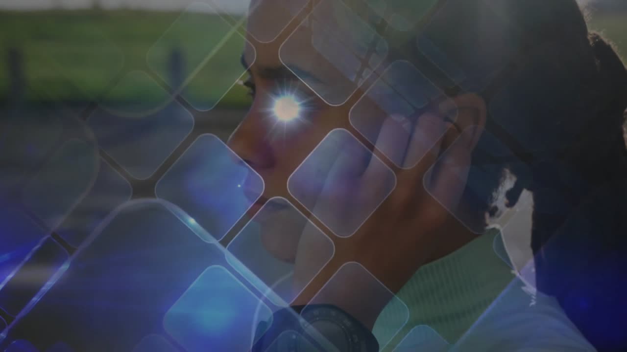 Woman holding smartphone to ear by field using tech overlay guiding earbud insertion for listening
