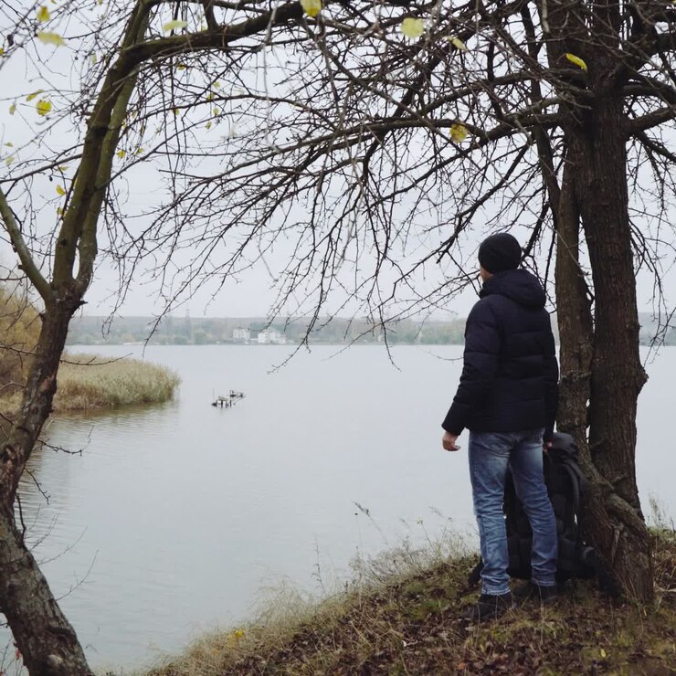 Man tourist standing near river