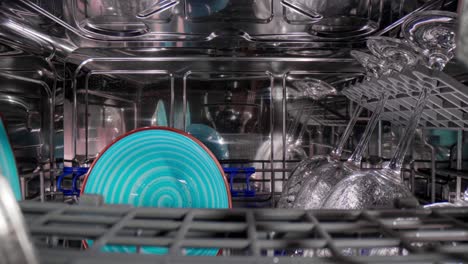 open dishwasher with clean dishes. housekeeping concept.