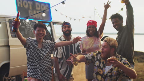 group portrait of excited multiethnic friends at summer festival