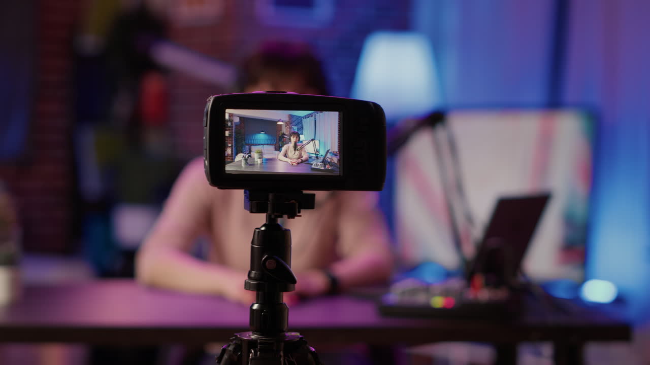 Selective focus on digital video camera screen recording content creator streaming live internet radio