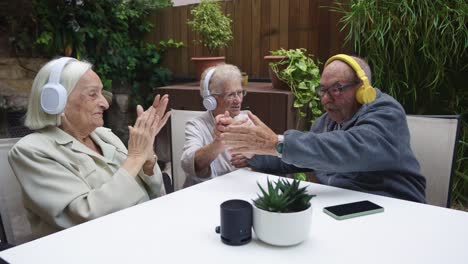 Senior citizens listening to music with headphones