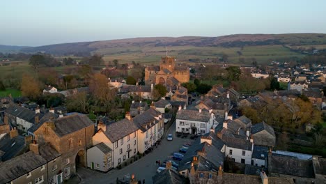 Aerial-footage-of-the-Medieval-village-of-Cartmel-in-the-English-Lake-District-it-has-a-rich-heritage,-and-varied-list-of-activities-for-visitors-and-tourists