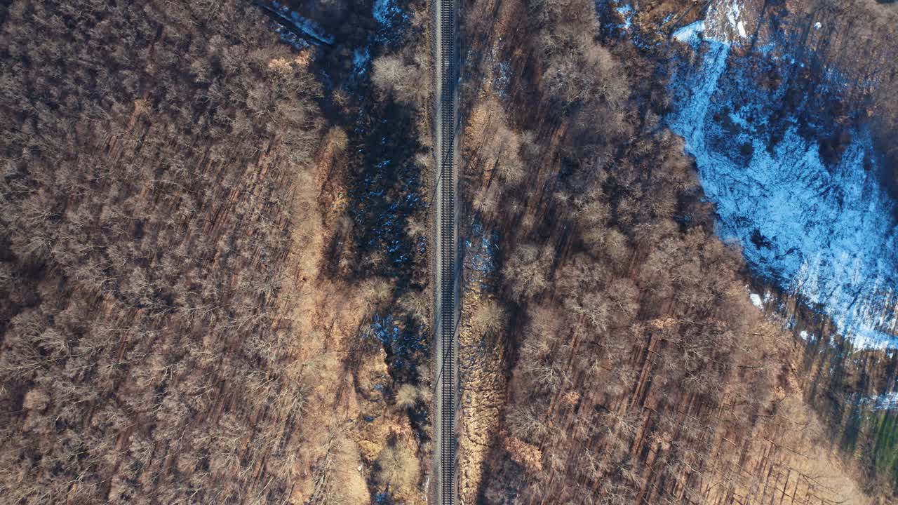 Railroad in winter landscape. Top aerial view of railroad and winter landscape with trees