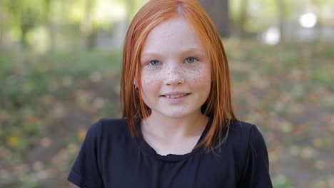 natural appearance of a girl with beautiful freckles on her face teenage girl with blue eyes and freckles on her face looks at the camera close up