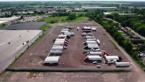 overview of yard parking lot with semi trucks and trailers - reefers, dry van, flatbeds, stingers, bob tails