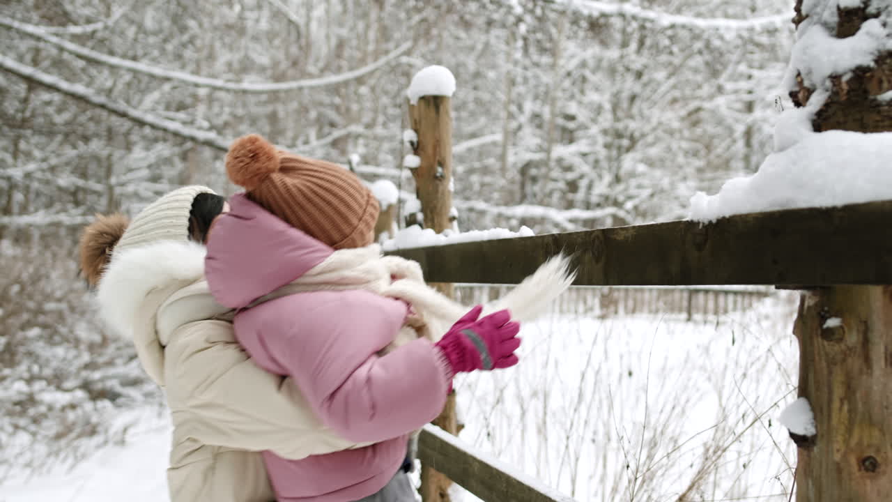 Mother and Daughter Playing in the Snow