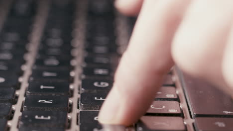 dolly in detail of fingers typing, pressing the buttons on modern wireless keyboard