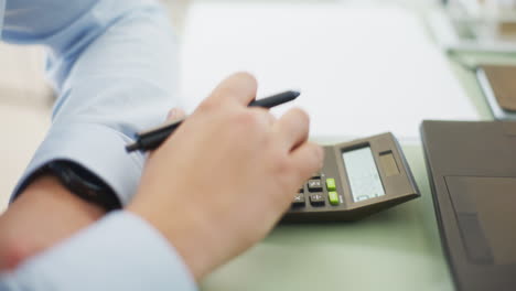 close-up of hand counting on calculator