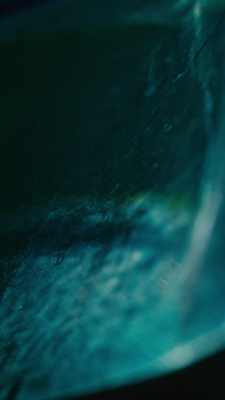 Close-Up of Blue and Green Light Reflecting on Textured Surface