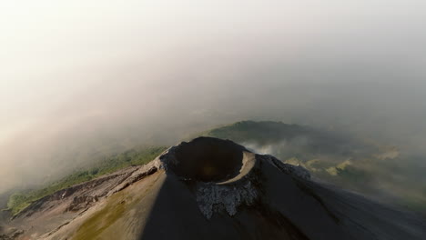 slow drone pan shot of active fuego volcano crater in guatemala during sunrise