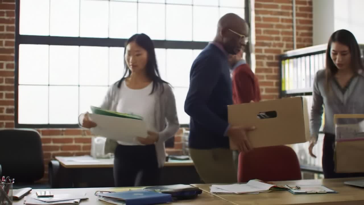 Employees engage in discussions and share documents in a vibrant office space filled with natural light. Teamwork and collaboration are evident as they tackle tasks together.