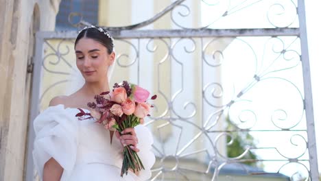 bride holds beautiful wedding bouquet before her face bride holds beautiful wedding bouquet before her face wedding day of bride in bridal gown