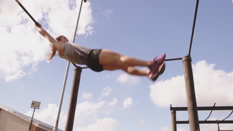 young woman training at an outdoor gym bootcamp