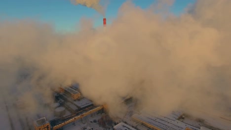 industrial plant with smoke emissions in winter