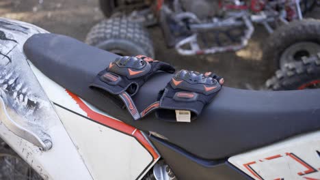 rugged off-road motorcycle gloves securely perched on the bike