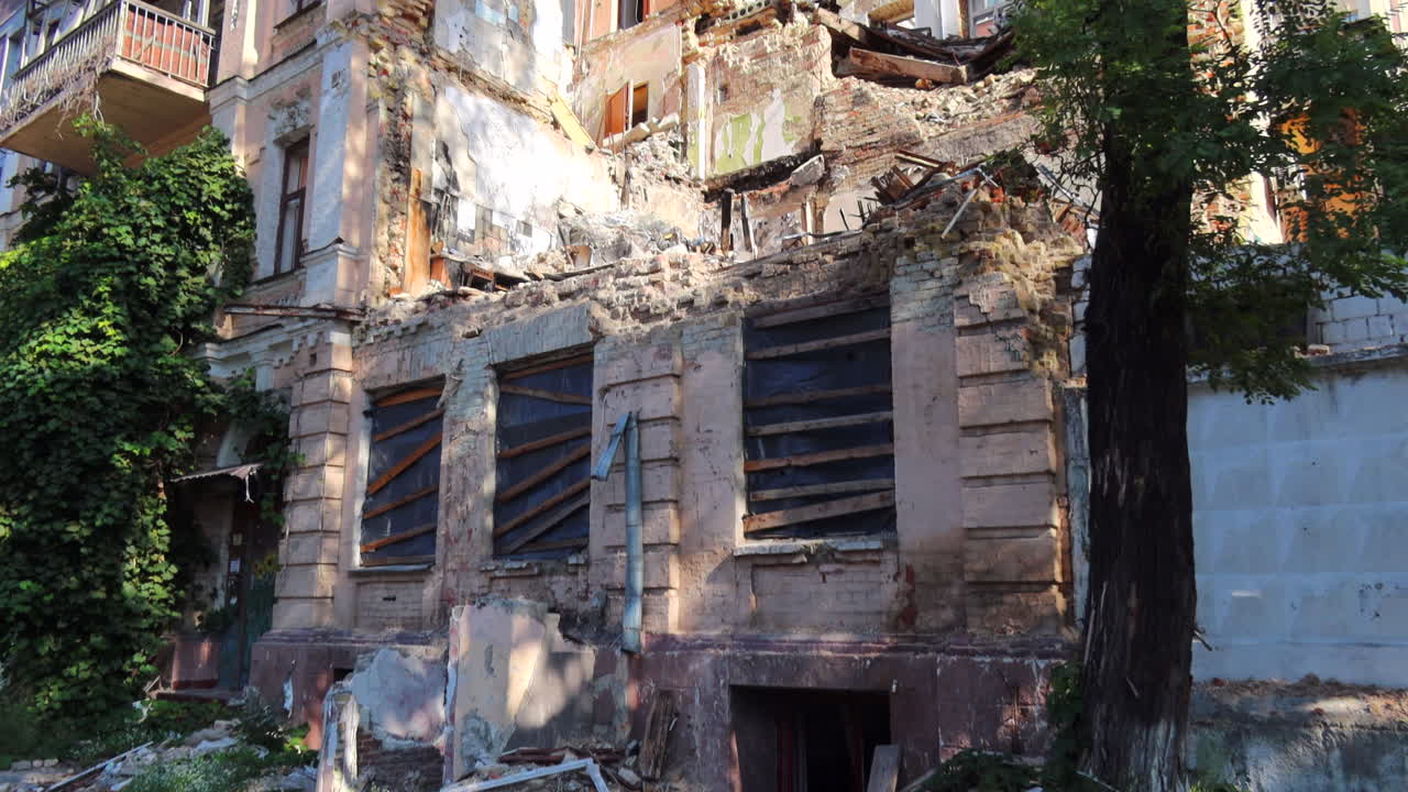 Destroyed and demolished civilian building by a big rocket in Kyiv Ukraine, critical war damage in the city capital, Russia attacks Ukraine, uninhabitable building, half of a house gone, 4K shot
