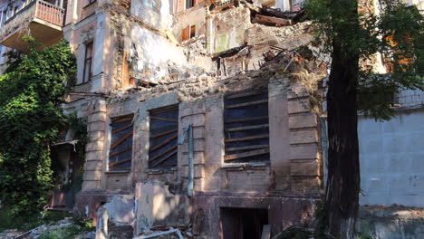 destroyed and demolished civilian building by a big rocket in kyiv ukraine, critical war damage in the city capital, russia attacks ukraine, uninhabitable building, half of a house gone, 4k shot