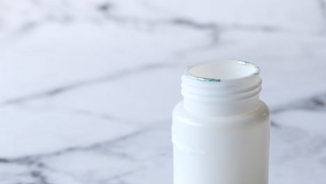 close-up of a white plastic bottle with tamper-evident seal