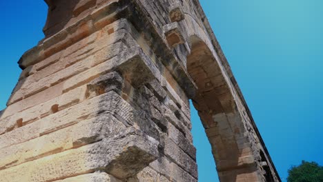 Low-angle-video-shoot-of-Pont-du-Gard,-a-famous-Roman-Aqueduct-on-the-Gardon-River-in-France