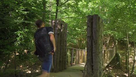 young man walking in the forest in slow motion.