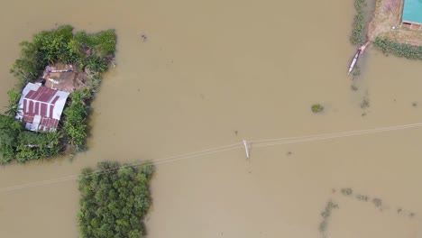 top view of an extreme flooded village with floating houses in bangladesh, south asia. aerial drone shot
