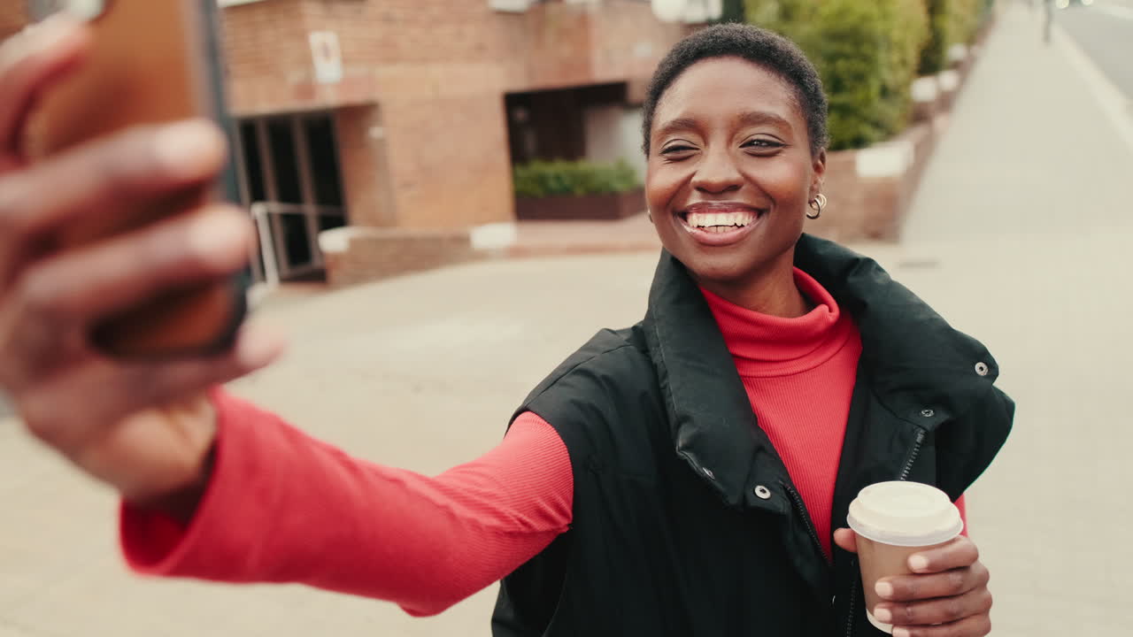 Happy Young African American Woman Taking a Selfie with Coffee on City Street