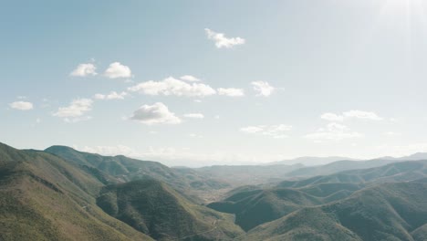 Tilt-down-shot-of-Clouds-and-green-mountains-of-landscape-in-Oaxaca,-mexico