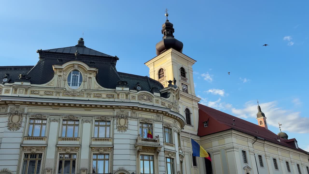 Holy Trinity Jesuit Church and Sibiu City Hall in daylight, Static handheld