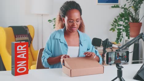 young african american woman influencer is filming review of new cosmetic cream