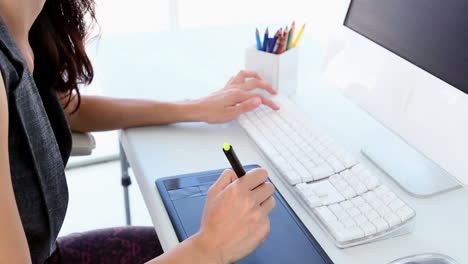 graphic designer working on digitizer at her desk