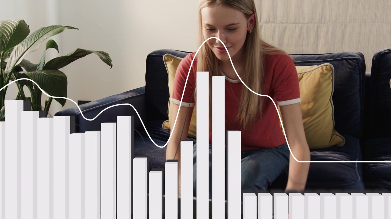 Woman sitting on couch, leaning in, pressing keyboard keys, audio visualizer reacting making music